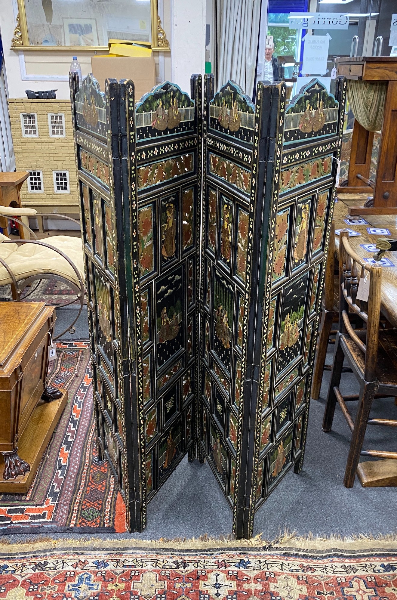 An Indian painted polychrome four fold screen, each panel width 40cm, height 137cm